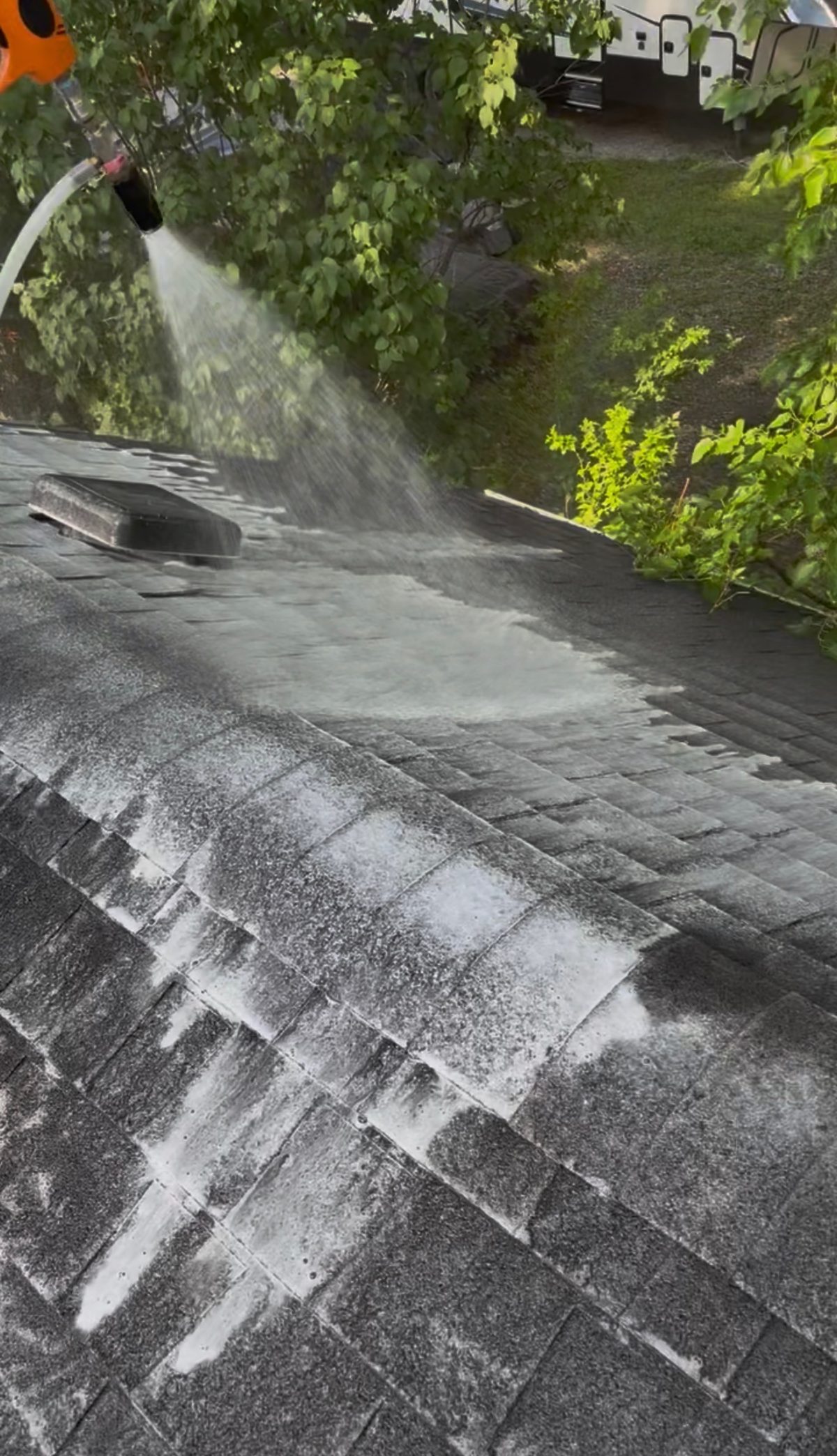 Soft-washing a roof — lifting algae and black streaks